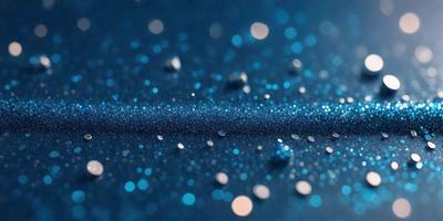 The primary subject of the image is a blue background with a pattern of blue glitter or sparkles. The setting appears to be a dark room, and the visual style is a close-up of the blue background with the glittery pattern. The colors and mood of the image are predominantly blue, with a sense of sparkle and shine.