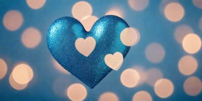 The primary subject of the image is a heart-shaped object, which is likely a piece of jewelry or a decorative item. The heart is made of blue glitter material, giving it a shiny and eye-catching appearance. The setting of the image is a blue background, which complements the blue heart and adds to the overall visual style. The heart is the main focus of the image, and its vibrant color and unique design create a lively and cheerful atmosphere.