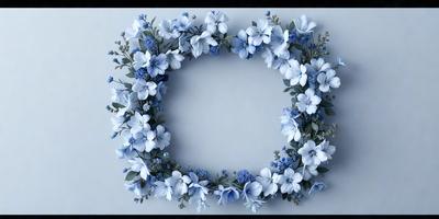 The primary subject of the image is a wreath made of white flowers, which is placed in the center of a round frame. The setting is a white background, which provides a clean and minimalist appearance. The visual style is a combination of photo and digital art, as the flowers are realistic and the wreath is well-defined. The colors and mood of the image are predominantly white and blue, creating a serene and calming atmosphere.