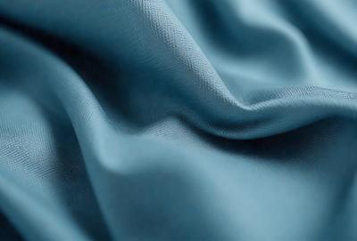 The primary subject of the image is a blue fabric, which is the main object, scene, or focus of the image. The setting or background is a blue cloth, and the visual style is a photo. The dominant colors and overall atmosphere are blue and calm.