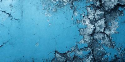 The primary subject of the image is a blue surface with a cracked and peeling appearance. The setting is a blue wall, and the visual style is a close-up of the blue surface. The colors and mood of the image are predominantly blue, with a slightly distressed and aged appearance.