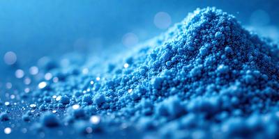 The primary subject of the image is a blue substance, possibly a powder or a liquid, with a blue background. The visual style appears to be a close-up of the blue substance, possibly a photo or a digital artwork. The colors and mood of the image are predominantly blue, creating a calm and serene atmosphere.