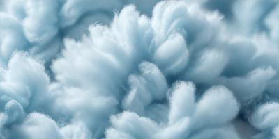 The primary subject of the image is a cloud, which is the main object, scene, or focus of the image. The cloud is set against a blue sky, creating a vibrant and lively atmosphere. The visual style of the image is a photo, capturing the beauty of the cloud in its natural environment. The colors and mood of the image are predominantly blue, with the cloud being the main source of visual interest and creating a sense of tranquility and serenity.