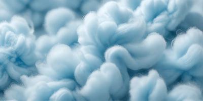 The primary subject of the image is a cloudy sky filled with fluffy, white clouds. The setting is a blue sky, which serves as the backdrop for the clouds. The visual style of the image is a combination of photo and digital art, creating a unique and artistic representation of the cloudy sky. The colors and mood of the image are predominantly blue and white, giving it a serene and calming atmosphere.