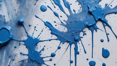 The primary subject of the image is a blue splatter pattern, which is the main object, scene, or focus of the image. The setting or background is a white surface, and the visual style appears to be a photo or a digital artwork. The dominant colors in the image are blue and white, creating a calm and soothing atmosphere.