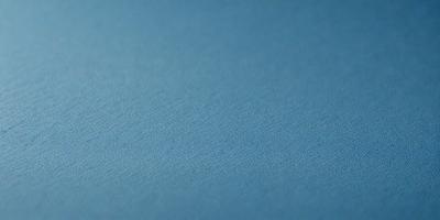 The primary subject of the image is a blue surface, which appears to be a piece of fabric or a wall. The setting is a room with a blue background, and the visual style is a close-up of the blue surface. The colors and mood of the image are predominantly blue, creating a calm and serene atmosphere.