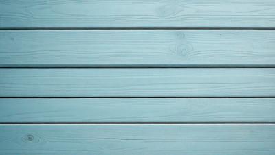 The primary subject of the image is a wooden wall with a blue color. The setting is a room with a blue wall, and the visual style is a photo. The dominant colors are blue and white, creating a calm and serene atmosphere.