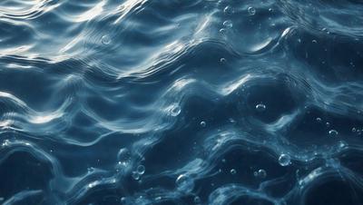 The primary subject of the image is a body of water, which appears to be a large blue ocean. The setting is underwater, with the water being the primary background. The visual style of the image is a photo, capturing the beauty of the underwater environment. The colors and mood of the image are predominantly blue, creating a serene and calming atmosphere.