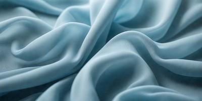 The primary subject of the image is a blue fabric, possibly a piece of cloth or a curtain. The setting is a room with a blue background, which creates a cohesive and visually appealing environment. The visual style of the image is a close-up of the blue fabric, showcasing its texture and details. The colors and mood of the image are predominantly blue, giving it a calm and serene atmosphere.