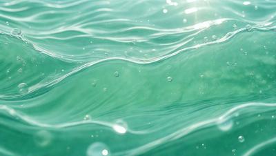 The primary subject of the image is a body of water, which appears to be a large lake or ocean. The water is filled with bubbles, creating a lively and dynamic atmosphere. The setting is outdoors, with the water being the main focus of the scene. The visual style of the image is a close-up of the water, showcasing the bubbles and their movement. The colors in the image are predominantly blue, which adds to the serene and calming mood of the scene.