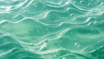 The primary subject of the image is a body of water, possibly an ocean or a large lake, with waves and bubbles. The setting is underwater, with the water appearing to be blue. The visual style is a close-up of the water, showcasing the waves and bubbles. The colors and mood of the image are predominantly blue, creating a serene and calming atmosphere.