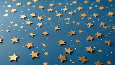 The primary subject of the image is a blue background with a pattern of stars. The setting is a dark blue surface, and the visual style appears to be a combination of a photo and digital art. The colors and mood of the image are predominantly dark and moody, with the stars providing a contrasting and luminous element.