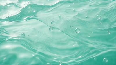 The primary subject of the image is a body of water, which appears to be a large pool of blue water. The water is filled with bubbles, creating a lively and dynamic atmosphere. The setting is outdoors, with the water being the main focus of the scene. The visual style of the image is a close-up of the water, showcasing the bubbles and the blue color of the water. The colors and mood of the image are predominantly blue, creating a sense of calmness and tran