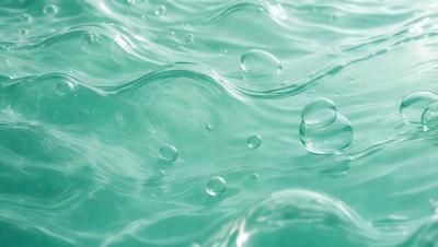 The primary subject of the image is a body of water, possibly a lake or a pool, with a blue color. The setting is a calm and serene environment, with no visible land or other objects. The visual style of the image is a close-up of the water, showcasing the bubbles and ripples on its surface. The colors and mood of the image are predominantly blue, creating a sense of tranquility and relaxation.