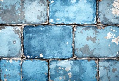The primary subject of the image is a blue brick wall. The setting is a brick wall with a blue tint, and the visual style is a photo. The dominant colors are blue and gray, creating a calm and serene atmosphere.
