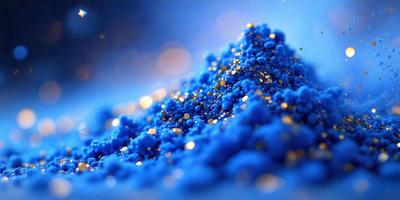 The primary subject of the image is a pile of blue glitter. The setting is a blue background, which creates a contrast with the glitter. The visual style is a close-up of the glitter, showcasing its texture and color. The colors and mood of the image are predominantly blue, with a touch of gold from the glitter, giving it a vibrant and lively appearance.