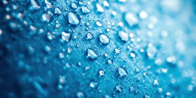 The primary subject of the image is a close-up of a blue surface with numerous tiny droplets of water on it. The setting appears to be a blue cloth or a blue background. The visual style is a close-up of the blue surface with water droplets, which gives the image a realistic and detailed appearance. The colors and mood of the image are predominantly blue, creating a calm and serene atmosphere.