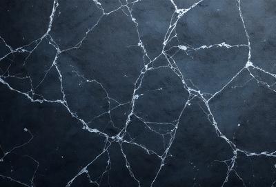 The primary subject of the image is a close-up of a black and white marble wall with a textured surface. The setting is a dark room, and the visual style appears to be a photo. The dominant colors are black and white, creating a moody atmosphere.