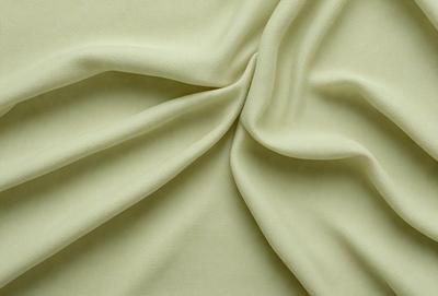 The primary subject of the image is a piece of fabric, which is the main object, scene, or focus of the image. The setting/background consists of a yellow cloth, and the visual style is a photo. The colors and mood of the image are predominantly yellow, creating a warm and inviting atmosphere.