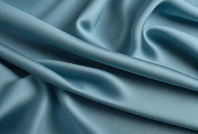 The primary subject of the image is a blue fabric, which is the main object, scene, or focus of the image. The setting or background is a blue cloth, and the visual style is a photo. The dominant colors and overall atmosphere are blue and serene.