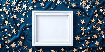 The primary subject of the image is a white frame with a blank canvas. The setting is a blue cloth with stars scattered across it. The visual style is a combination of a photo and digital art, creating a unique and artistic appearance. The colors and mood are predominantly blue and white, with the stars adding a touch of warmth and interest to the overall atmosphere.