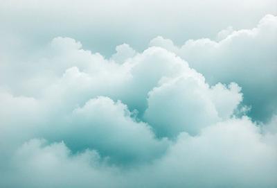 The primary subject of the image is a cloudy sky filled with various cloud formations. The setting is a blue sky, which creates a serene and calming atmosphere. The visual style is a natural, outdoor scene, with no indication of digital art or illustration. The colors and mood are predominantly blue, which adds to the peaceful and tranquil ambiance of the image.