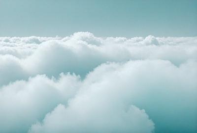 The primary subject of the image is a cloudy sky filled with white clouds. The setting is a vast, open space with no visible landmarks or objects. The visual style is a natural, outdoor scene with a focus on the clouds. The colors and mood of the image are predominantly white and serene, creating a peaceful and tranquil atmosphere.