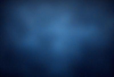The primary subject of the image is a blue sky with a few clouds. The setting is a dark blue background, which creates a contrasting effect with the lighter blue sky. The visual style is a natural, outdoor scene. The colors and mood of the image are predominantly dark and moody, with the blue sky and clouds providing a sense of depth and tranquility.