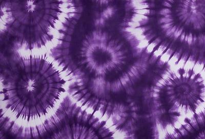 The primary subject of the image is a purple tie-dye fabric with a pattern of swirls and circles. The setting is a close-up view of the fabric, showcasing its intricate design. The visual style is a combination of a photo and a digital art, as the image appears to be a close-up of a tie-dye fabric. The colors and mood of the image are predominantly purple, creating a calm and relaxing atmosphere.