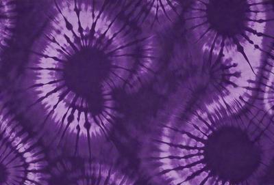 Purple tie-dye fabric with a pattern of circles.