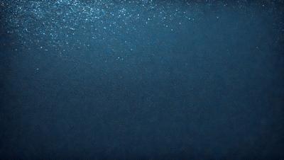 The primary subject of the image is a large body of water, which appears to be a deep blue ocean. The setting is a vast expanse of water, with no visible land or other objects in the background. The visual style of the image is a close-up of the water, showcasing its depth and beauty. The colors and mood of the image are predominantly blue, creating a serene and tranquil atmosphere.