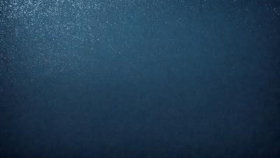 The primary subject of the image is a large body of water, which appears to be a deep blue ocean. The setting is a vast expanse of water, with no visible land or other objects in the background. The visual style of the image is a close-up of the water, showcasing its depth and beauty. The colors and mood of the image are predominantly blue, creating a serene and tranquil atmosphere.