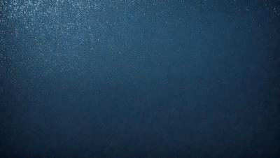 The primary subject of the image is a large body of water, which appears to be a deep blue ocean. The setting is a vast expanse of water, with no visible land or other objects in the background. The visual style of the image is a close-up of the water, showcasing its depth and beauty. The colors and mood of the image are predominantly blue, creating a serene and tranquil atmosphere.