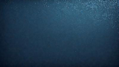 The primary subject of the image is a large body of water, which appears to be a deep blue ocean. The setting is a vast expanse of water, with no visible land or other objects. The visual style of the image is a close-up of the water, showcasing its depth and beauty. The colors and mood of the image are predominantly blue, creating a serene and tranquil atmosphere.