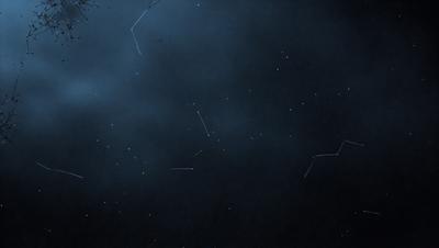 The primary subject of the image is the night sky, which is filled with stars. The setting is a dark, cloudy night, creating a moody atmosphere. The visual style is a photo of the night sky, capturing the beauty of the stars and the vastness of the universe. The colors and mood of the image are predominantly dark and mysterious, with the stars providing a glimmer of light and hope.