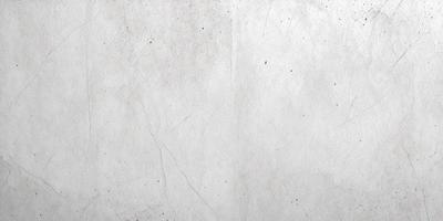 The primary subject of the image is a white wall with a rough texture. The setting is a room with a white wall, and the visual style is a close-up of the wall. The colors and mood of the image are predominantly white, giving it a clean and minimalist appearance.
