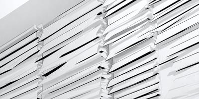 The primary subject of the image is a white, textured surface with a pattern of vertical lines. The setting appears to be a white room, and the visual style is a combination of digital art and illustration. The dominant colors are white and gray, creating a clean and minimalist atmosphere.