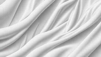 The primary subject of the image is a white sheet of fabric, which is the main object, scene, or focus of the image. The setting or background is a white surface, which provides a clean and minimalistic backdrop for the fabric. The visual style of the image is a close-up of the fabric, showcasing its texture and details. The colors and mood of the image are predominantly white, giving it a clean, simple, and serene atmosphere.