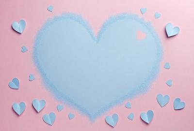 The primary subject of the image is a heart-shaped paper cutout. The heart is placed on a pink background, which adds a warm and romantic touch to the scene. The visual style of the image is a combination of digital art and illustration, as the heart is created using a paper cutout technique. The colors and mood of the image are predominantly pink, which evokes feelings of love and affection.