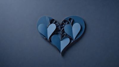The primary subject of the image is a heart-shaped paper cutout. The heart is made of blue paper and is placed on a blue background. The visual style of the image is a combination of digital art and illustration, as the heart is a digital creation. The colors and mood of the image are predominantly blue, creating a calm and serene atmosphere.