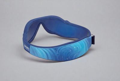 The primary subject of the image is a blue headband with a design of waves. The headband is placed on a white background, giving it a clean and minimalist appearance. The visual style of the image is a combination of digital art and illustration, as the waves are depicted in a detailed and artistic manner. The colors and mood of the image are predominantly blue, creating a calm and soothing atmosphere.