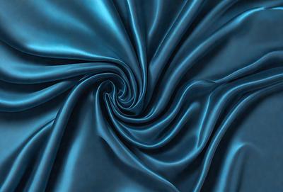 The primary subject of the image is a blue fabric, which appears to be a piece of silk. The setting is a close-up of the fabric, showcasing its texture and pattern. The visual style is a detailed, artistic representation of the fabric, possibly as a digital art or illustration. The colors and mood of the image are predominantly blue, creating a calm and serene atmosphere.