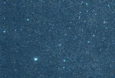 The primary subject of the image is the night sky, which is filled with stars. The setting is a dark, star-filled sky, and the visual style is a photo of the night sky. The colors and mood of the image are predominantly dark and serene, with the stars providing a sense of depth and beauty.