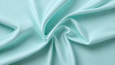 The primary subject of the image is a piece of blue fabric, which is the main object, scene, or focus of the image. The setting or background of the image is a blue surface, which adds to the overall atmosphere. The visual style of the image is a close-up of the blue fabric, showcasing its texture and pattern. The colors and mood of the image are predominantly blue, creating a calm and serene atmosphere.