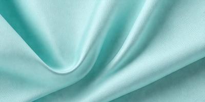 The primary subject of the image is a piece of blue fabric, possibly a leather material. The setting is a close-up view of the fabric, showcasing its texture and color. The visual style is a detailed, up-close representation of the fabric. The colors and mood of the image are predominantly blue, creating a calm and serene atmosphere.