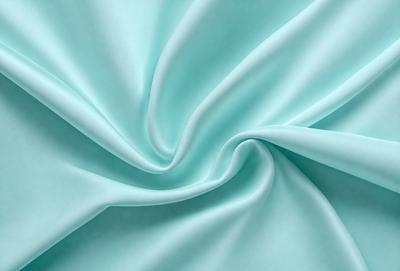 The primary subject of the image is a piece of blue fabric, which is the main object, scene, or focus of the image. The setting or background of the image is a blue cloth, and the visual style appears to be a photo. The dominant colors in the image are blue, and the overall atmosphere is calm and serene.