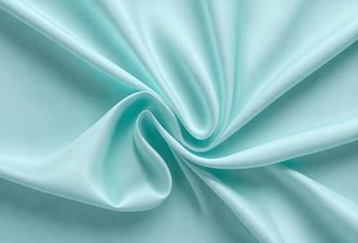 The primary subject of the image is a piece of blue fabric, which is the main object, scene, or focus of the image. The setting or background of the image is a blue cloth, and the visual style appears to be a photo. The dominant colors in the image are blue, and the overall atmosphere is calm and serene.