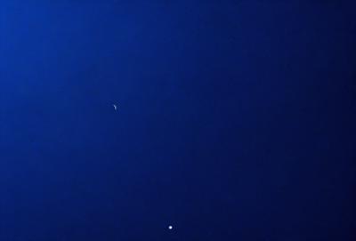 The primary subject of the image is the night sky, which is filled with stars. The setting is a dark, starry night, with the sky being the main focus of the image. The visual style is a photo of the night sky, capturing the beauty of the stars and the vastness of the universe. The colors and mood of the image are predominantly dark, with the stars being the main source of light and creating a serene and peaceful atmosphere.