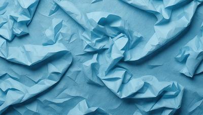 The primary subject of the image is a blue sheet of paper with a wrinkled texture. The setting is a blue background, and the visual style appears to be a photo. The colors and mood of the image are predominantly blue, creating a calm and serene atmosphere.