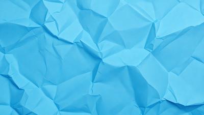 The primary subject of the image is a blue background with a pattern of folded paper. The setting is a blue background, and the visual style is a pattern of folded paper. The colors and mood of the image are predominantly blue, creating a calm and soothing atmosphere.